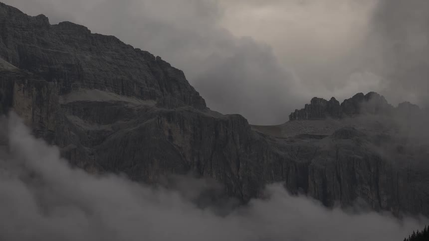 A stunning timelapse of misty clouds rolling through a dramatic and rugged mountain landscape