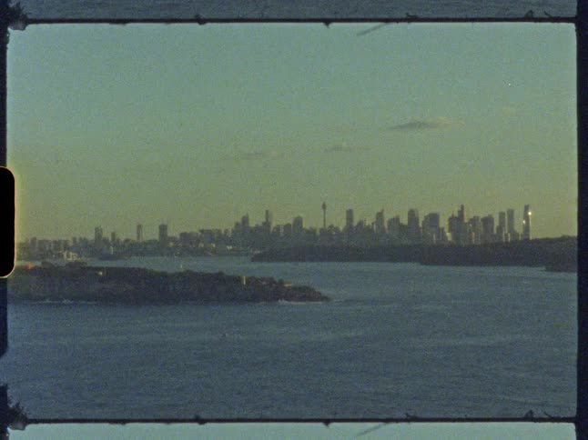 A nostalgic Super 8 film shot of the Sydney, Australia skyline viewed from across the water