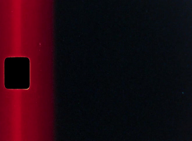 A dynamic stop-motion animation of vintage film effects, showcasing colorful light leaks, grain, and sprocket holes for a retro overlay