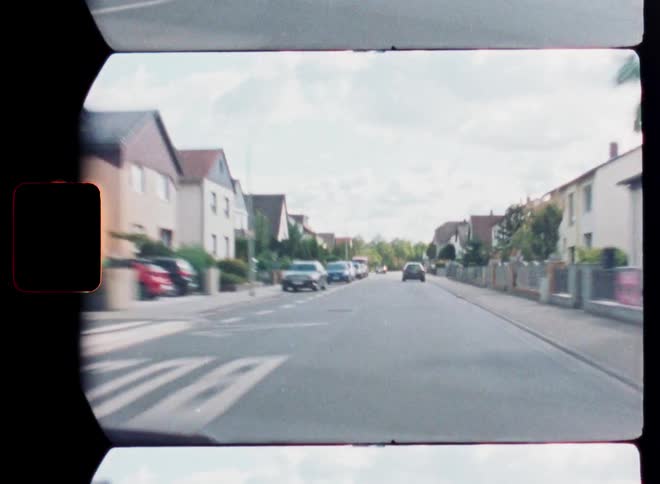 A nostalgic point-of-view drive through a suburban German town captured on vintage film