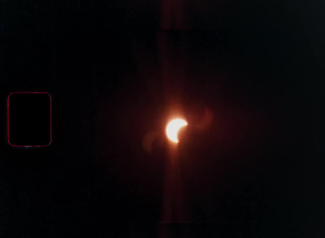Archival 16mm film footage shows a partial solar eclipse with lens flare and film grain