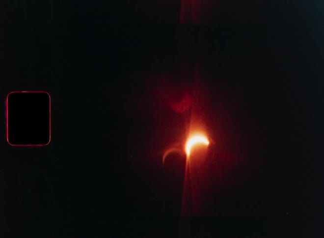 Vintage 8mm film footage captures the progression of a solar eclipse with prominent lens flares and film grain