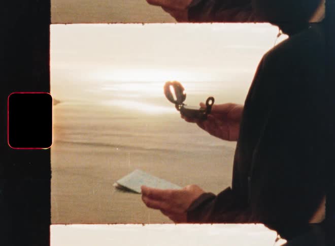 An explorer holds a vintage compass and a map while overlooking a vast fjord at sunset, captured with a nostalgic film aesthetic