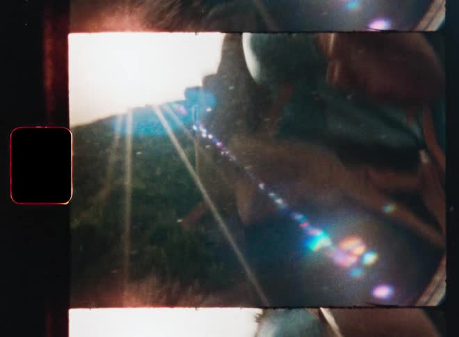 Vintage film captures a first-person perspective of reaching for a friend's hand while hiking in the bright sun
