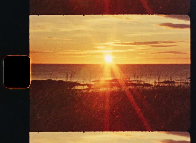 A beautiful sunrise over the ocean is captured on vintage film with authentic sprockets and light leaks