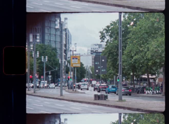 Split-frame analogue film footage of cars and scooters driving down a busy, tree-lined city street