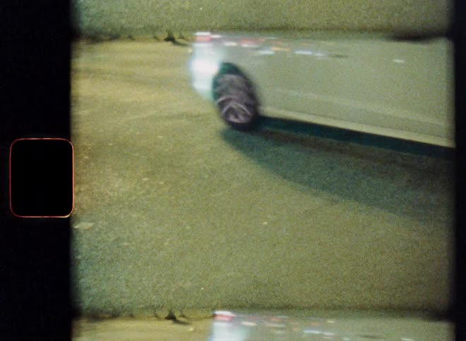 Split-screen vintage film shot of cars driving down an urban street at night from a high angle