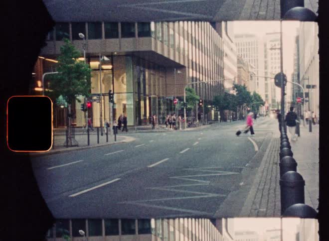 A vintage film-style time-lapse of a busy city street with cars and pedestrians moving through the urban landscape
