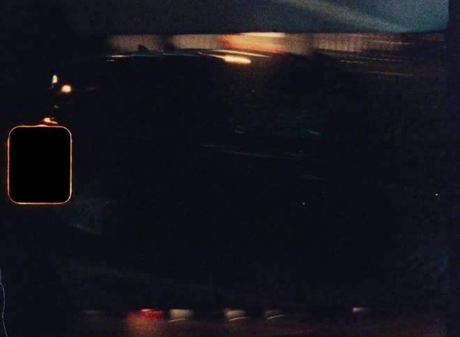 Vintage-style 8mm footage captures the motion blur of city traffic at night