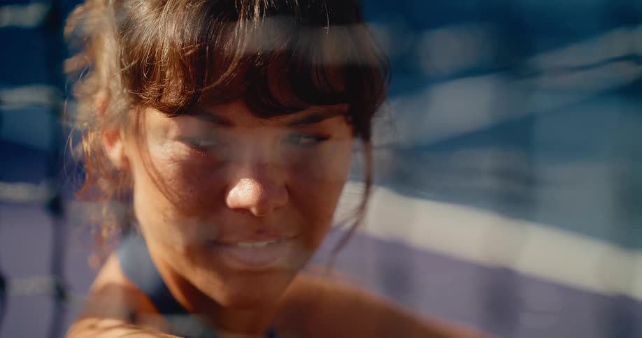 Dreamy slow motion portrait of a young woman with a gentle smile, basking in the warm afternoon sunlight