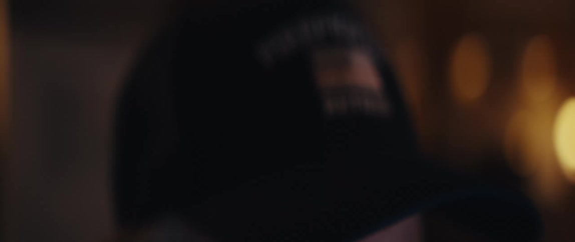 A slow focus reveals a hat with an embroidered 'Retired Firefighter' patch and a thin red line American flag