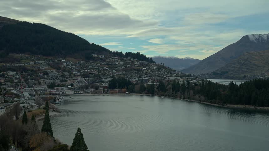 Stunning aerial footage shows the picturesque mountain town of Queenstown on the shores of a vast lake in New Zealand