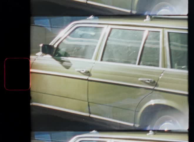 An 8mm film scan shows a close-up of a vintage station wagon with visible sprocket holes and light leaks