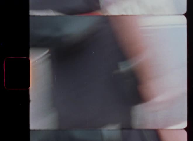 Layered, split-frame 8mm film captures the abstract, blurry motion of pedestrians on a city sidewalk