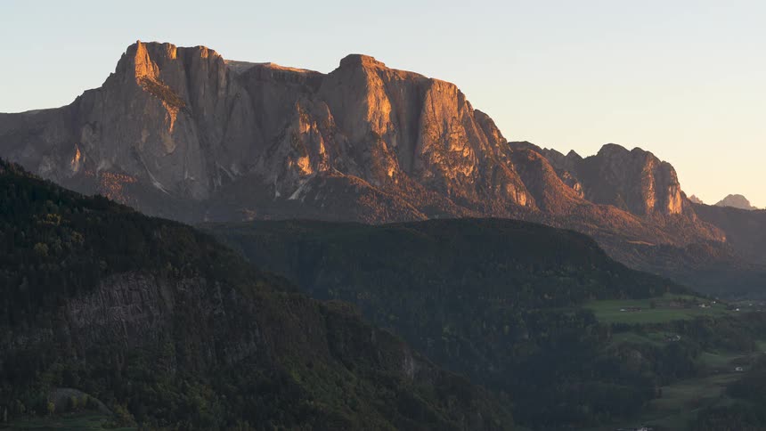 A stunning timelapse captures the golden hour sunset as light and shadows move across the majestic Schlern mountain in the Dolomites