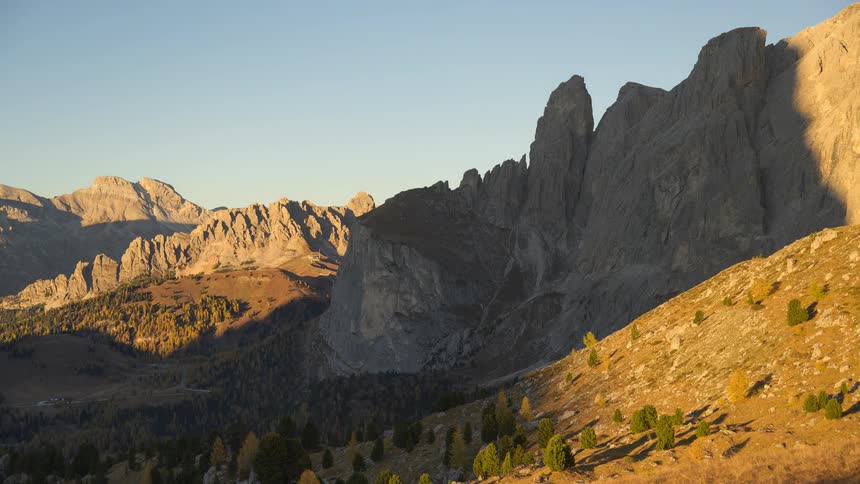 A breathtaking time-lapse shows the sun rising over the majestic Dolomites, as shadows recede across the alpine valley in autumn
