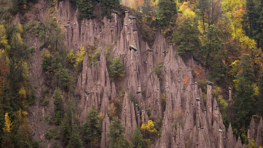 Time-lapse of fog and clouds rolling over the unique Earth Pyramids of Ritten in the Italian Alps during a moody autumn day
