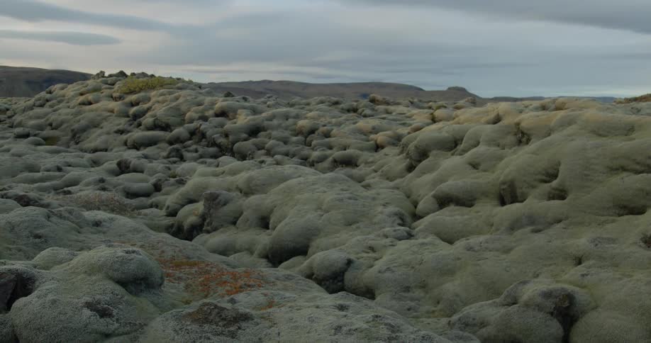 A slow zoom out reveals an otherworldly Icelandic landscape of vast, moss-covered lava fields