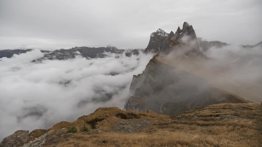 Time-lapse of thick fog and clouds rolling through the dramatic peaks of the Seceda ridgeline in the Italian Dolomites