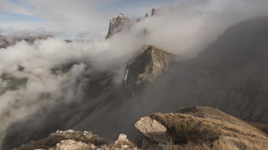 A stunning time-lapse of clouds and fog rolling through the majestic peaks of a rugged mountain range