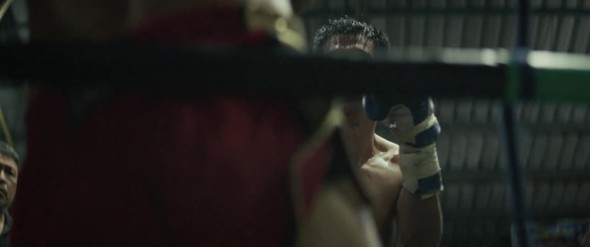 Slow motion close-up of two sweaty boxers trading powerful punches in a gritty boxing ring
