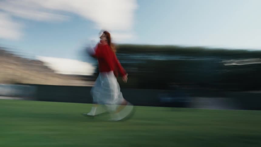 A woman running in a motion blur across a lawn transitions to a static shot of a historic building in Paris