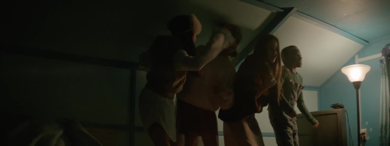 Four kids jump on a bed and sing