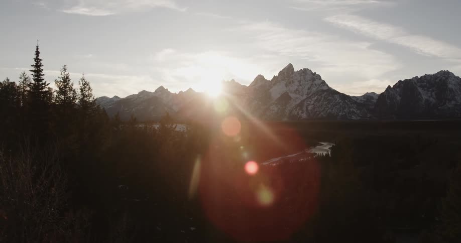 The sun i setting behind the mountain ahead