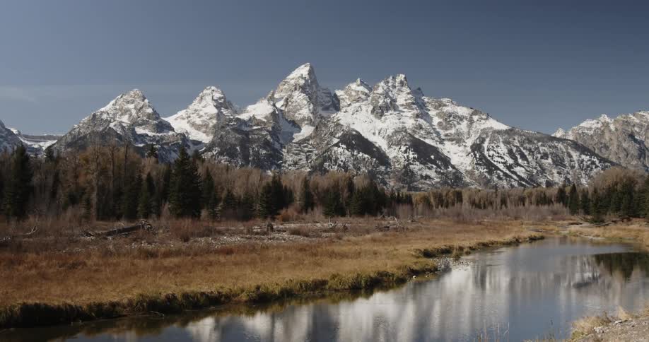 A stream runs towards a ice covered mountain