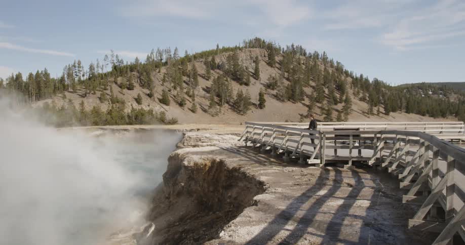 A tourist overlooks hot springs in a national park