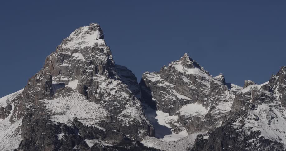 Snow covers rocky mountain peaks