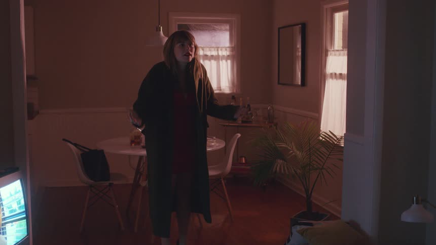 Woman yelling at a man as she puts her coat on