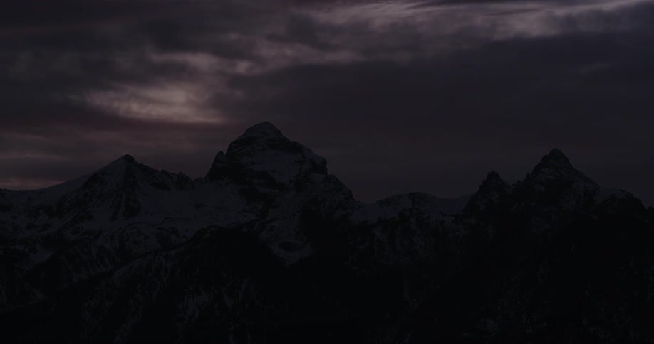 The sun is setting over the mountains