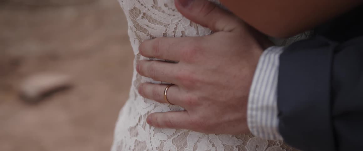 A man squeezes a woman's waist