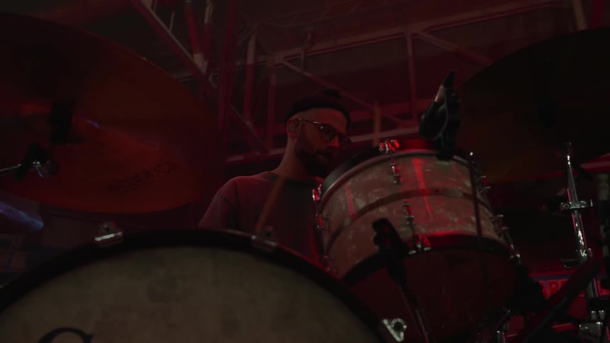 Man playing the drums with flashing lights