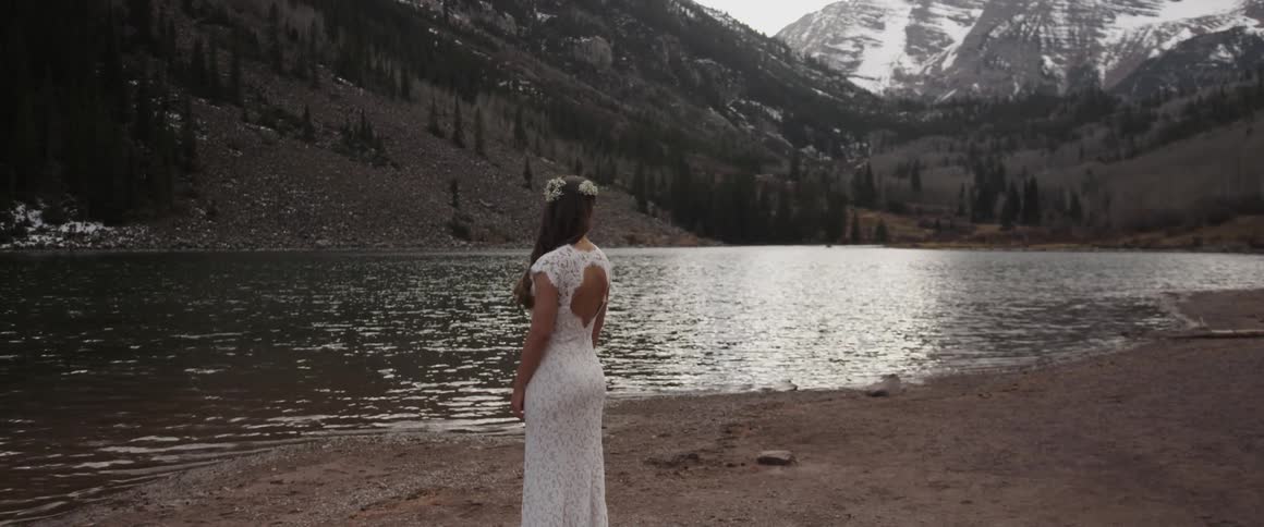 A woman turns towards water