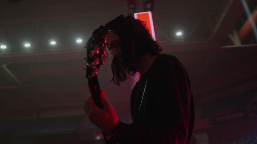 A man plays a guitar at a concert