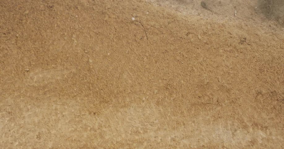 Water flowing over sand