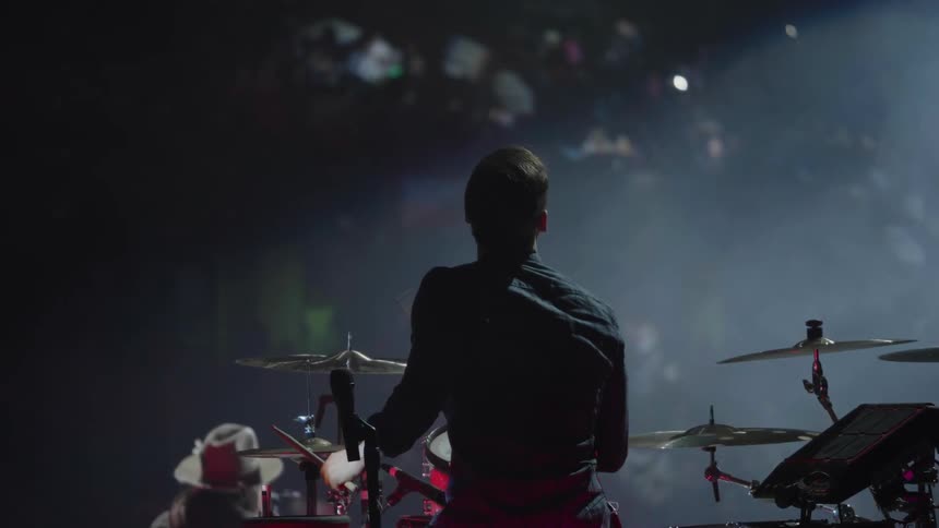 Man playing the drums on stage