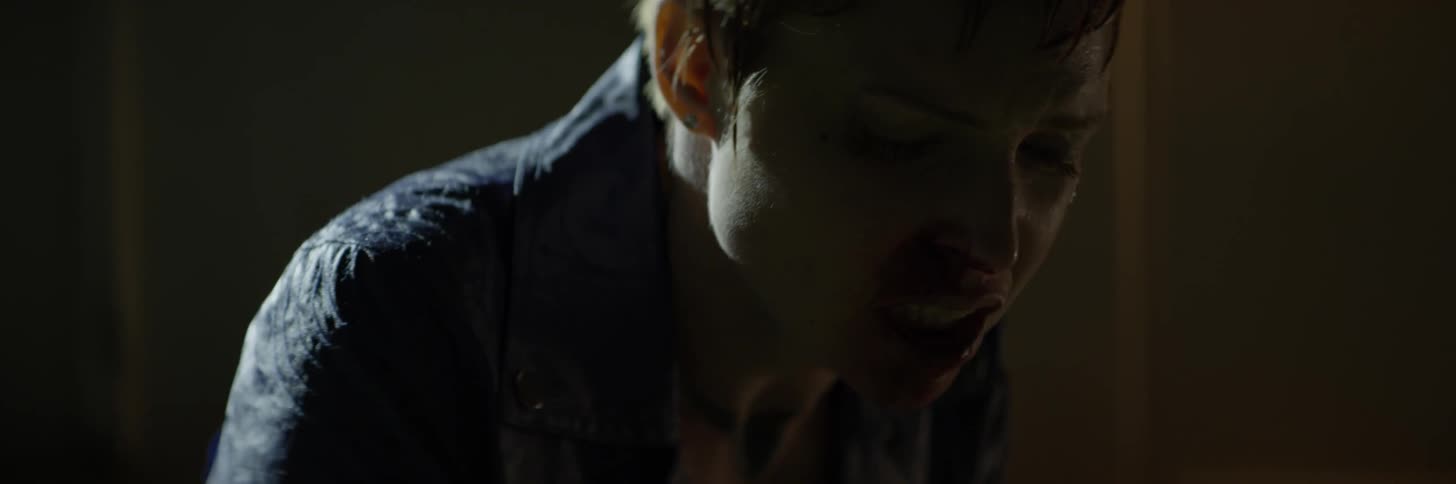 Woman breathes heavily outside at night
