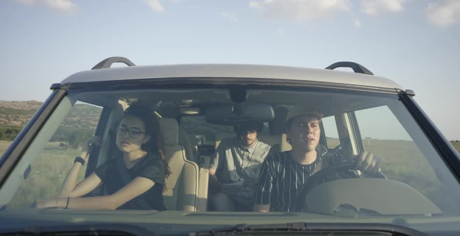 A group of people traveling in a car in the country