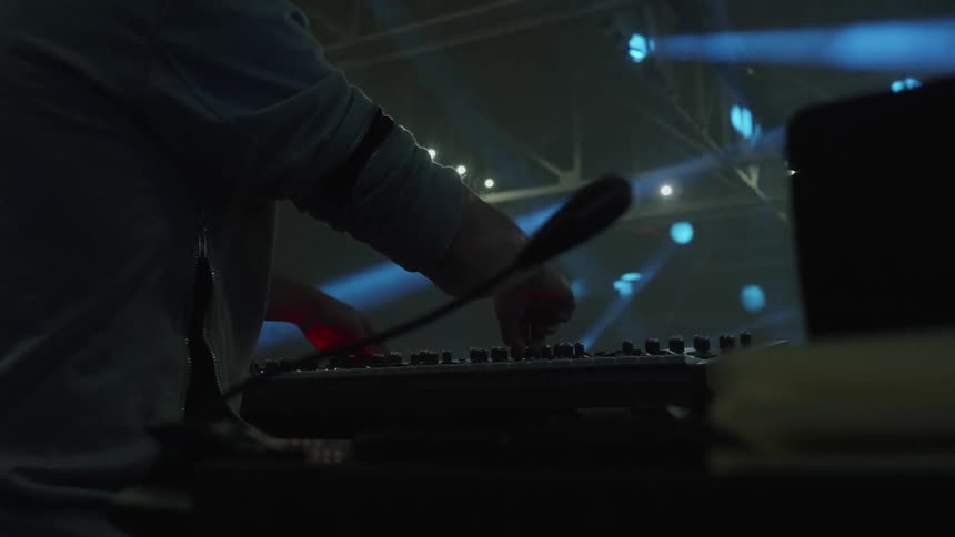 A man adjusts knobs on some equipment
