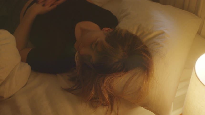 A woman is resting in bed