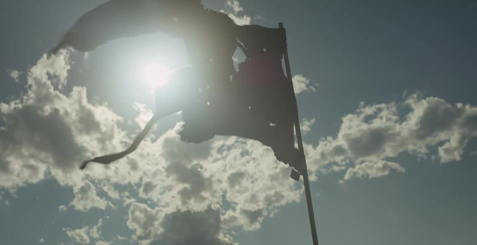 A tattered flag bows in the wind