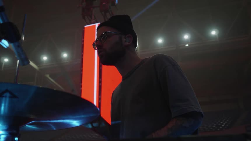 Man playing the drums on stage