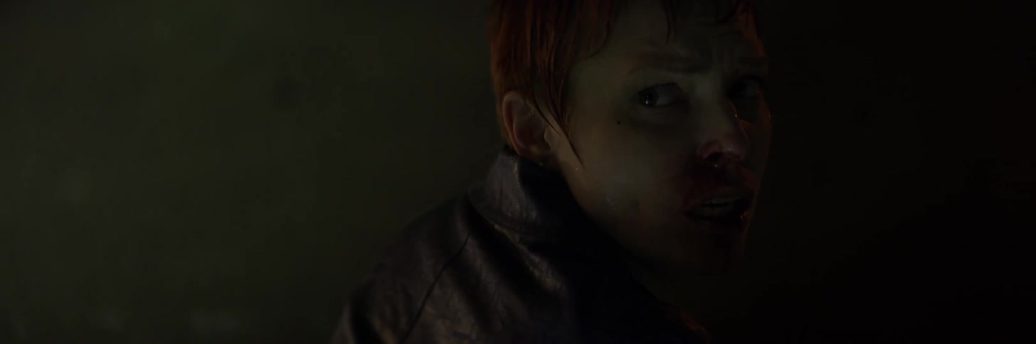 A woman's face is covered with blood
