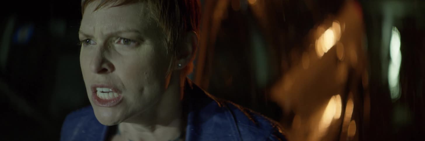 A red haired woman yells in the rain