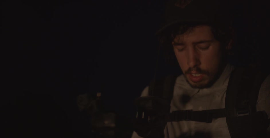 A photographer works outside at night