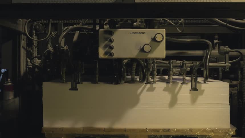 A large piece of machinery working on a white block