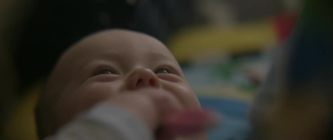 A baby is happy laying in bed